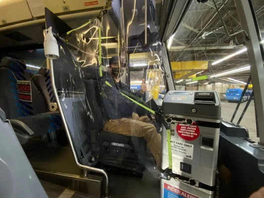 Interior view looking at an RFTA bus driver giving a thumbs up