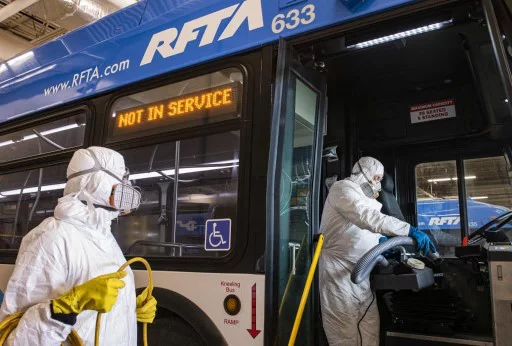 People with hazmat suits cleaning the interior of an RFTA bus