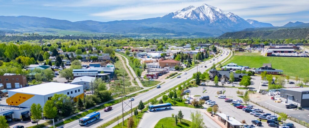 Aerial view of the town of Carbondale, Colorado. Shown is Mount Sopris in the distance with RFTA buses in the foreground.